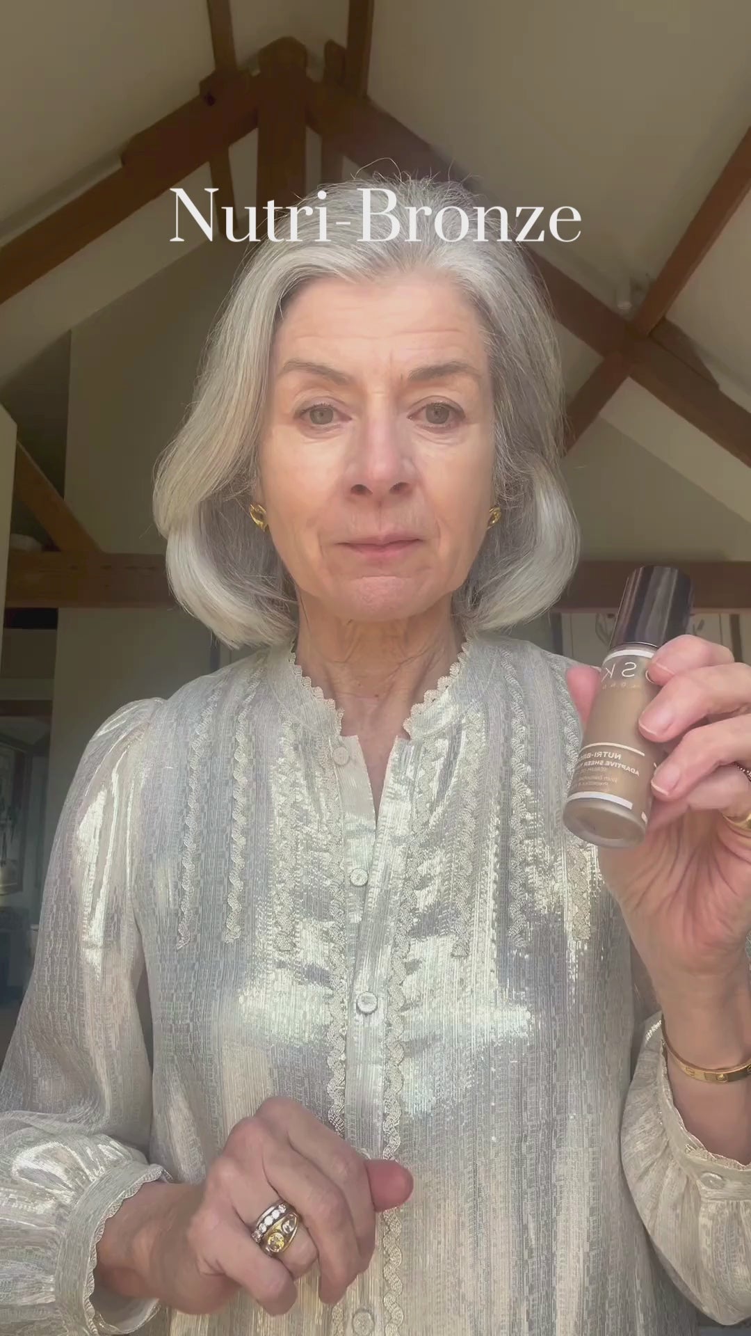 A video of an older woman applying our Nutri-Bronze Adaptive Sheer Tinted Serum
